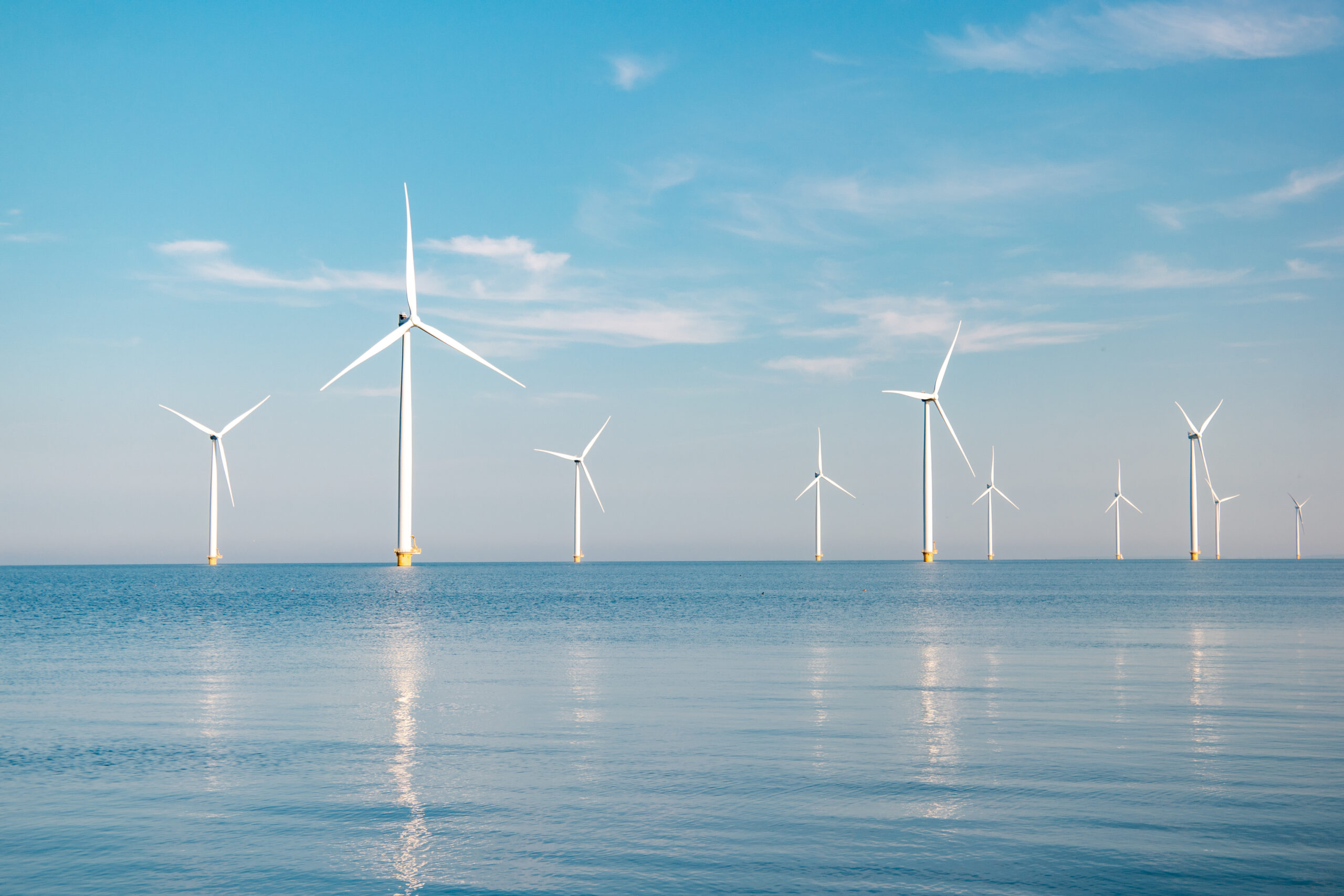 Offshore,Windmill,Park,With,Stormy,Clouds,And,A,Blue,Sky,